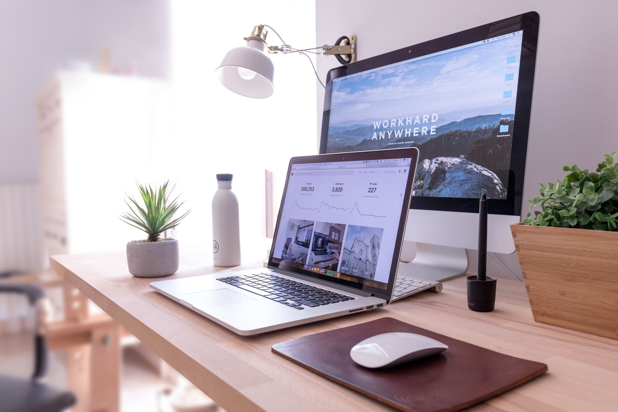 A laptop and an Apple monitor on the workstation of one of the digital marketing agency's coworkers.