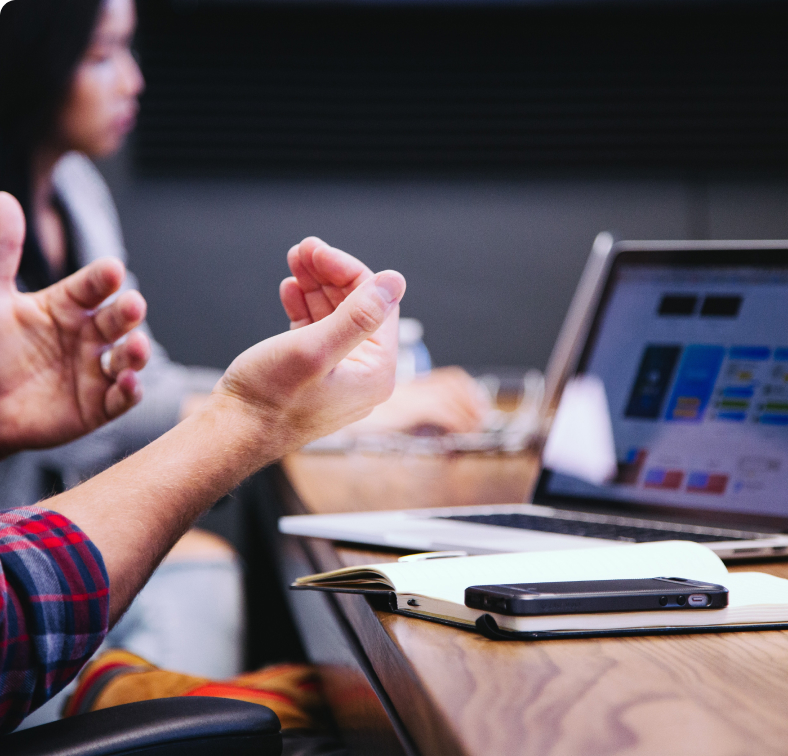 The digital marketing agency's coworker sits at a conference table and discusses his company's philosophy and work approach.